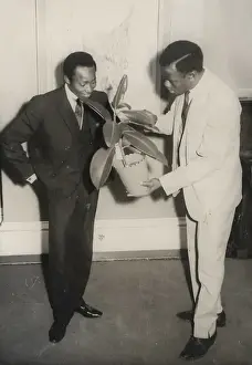 Two African men with a rubber plant in Nottingham