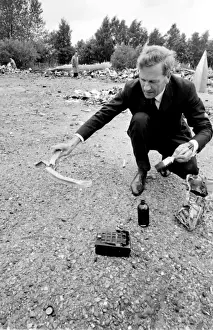Air crash investigator examining debris