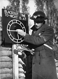 Adjusts Gallery: An Air Raid Warden adjusts the Blackout Time indicator