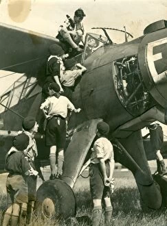 Air Planes Gallery: Air Scouts climbing on plane with Lord Olivier
