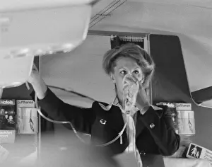 Emergency Prints: Air stewardess demonstrating oxygen mask