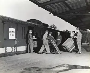Erding Prints: Airmen and German Men Using Wheel-Barrows Loading an Op?