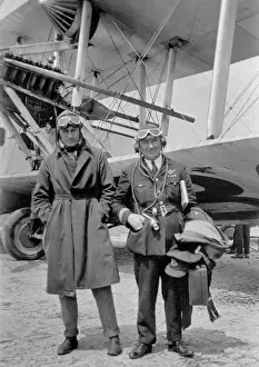 Raincoat Prints: Two airmen standing in front of plane