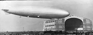 Airship Los Angeles in the air alongside its hangar