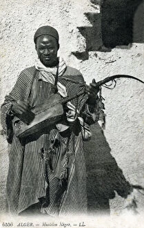 Lute Gallery: Algeria - African Gnawa Musician playing a traditional sintir, also known as the guembri