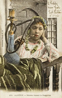 Algeria - Woman smoking a nargile pipe