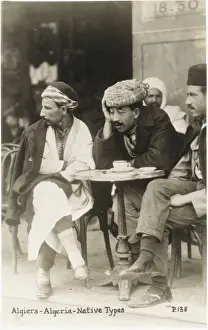 Crossed Prints: Algerian men drinking outside a cafe - Algiers