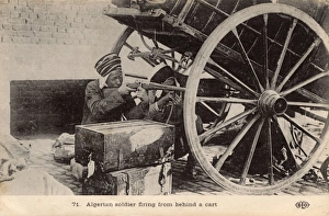 Two Algerian soldiers firing from behind the cover of a cart Two Algerian soldiers firing from behind the cover of a cart