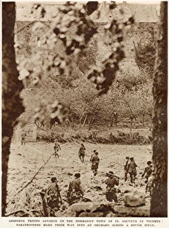 American airborne troops advancing through an orchard to the town of St