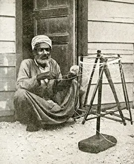 Arab fisherman winding twine for nets, Port Said, Egypt