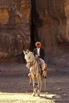Bridle Collection: Arab man on grey Arabian horse