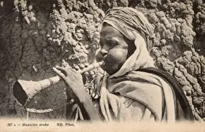 Puffed Prints: Arab Musician blowing a small horn - Algeria