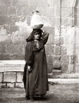 Arab peasant woman carrying water, Egypt, circa 1880. Date: circa 1880