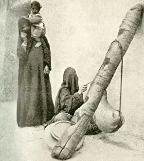 Arab woman with goatskin butter churn, near Cairo, Egypt