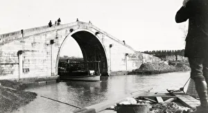 Arched stone bridge and boat, China. c. 1910