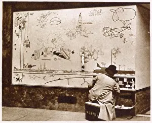 Homefront Prints: Artist Norman Keene replicating the original drawings done by William Heath Robinson on boarded up shop fronts