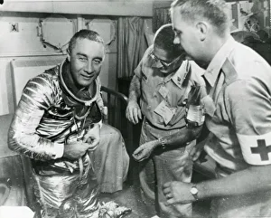 Altitude Gallery: Astronaut Virgil ?Gus? Grissom starts to remove his spa?