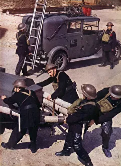 Pull Prints: Auxiliary Fire Service (A. F. S. ) Men hauling the Trailer-pump