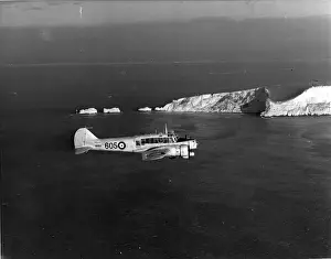 Anson Prints: Avro Anson I MK614 of the Royal Navy flies past the Needles
