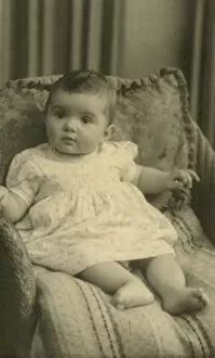 Baby on cushions, sitting up in a chair