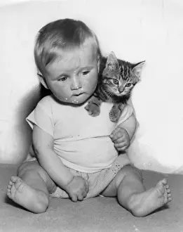 Baby with tabby kitten