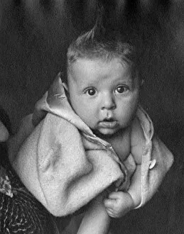 Images Dated 28th February 2012: Baby wrapped in a woolly coat