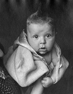 Images Dated 28th February 2012: Baby wrapped in a woolly coat