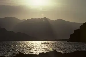 Activities Prints: Backlit boat beneath the Taurus mountains, Antalya, Turkey