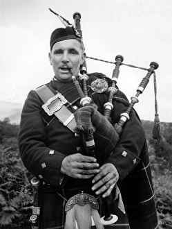 Bagpiper in the Trossachs, Scotland