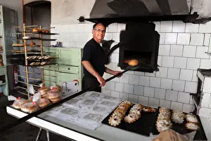 Baker Juan Olives bakes bread in olive wood burning oven
