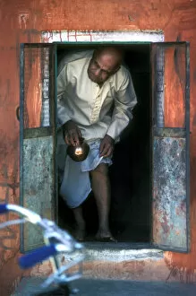 Images Dated 5th September 2019: A bald man comes through a small door in a shrine in Jaipur