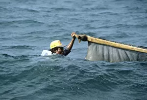 Bali fisherman up to his neck in water