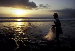 Contre Collection: A Balinese fisherman pauses to look at the sunset