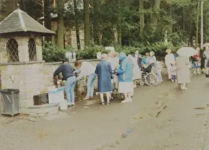 At Banneux, Belgium, where the Virgin Mary appeared to Mariette Beco in 1933, pilgrims stock up with water from the sacred spring which she caused to flow Date: 1990