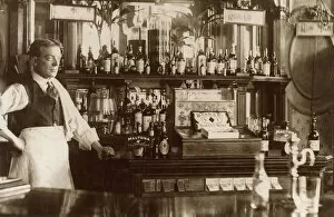 Packet Collection: Barman standing by well-stocked bar