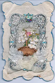 Basket of flowers on a paper lace greetings card