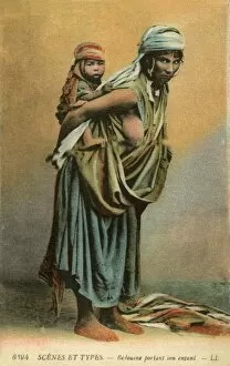 Bedouin woman carrying her child