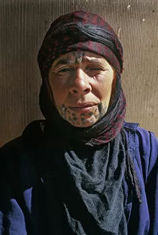 Syria Gallery: Bedouin woman with face tattoos outside her tent, Syria