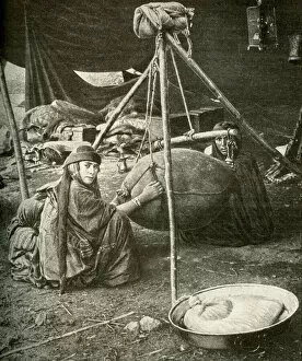 Bedouin women making butter in a goatskin, Arabia