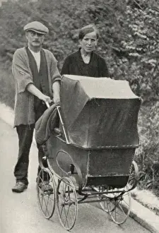 Beggar couple with child in pram