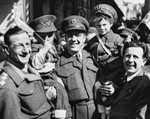 Two Belgian boys dressed as British soldiers with adults during World War II