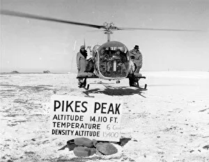 Peak Collection: Bell Model 47G-3 hovers atop Pikes Peak with pilot and f?