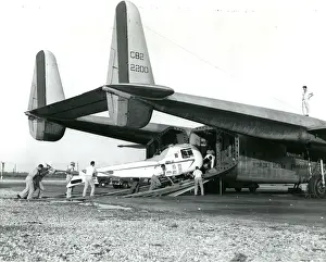 A Bell Model 47J being loaded into a Fairchild C-82 of t?