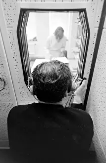Tests Prints: Biomedical centre, London -- a patient in a locked room listens to something through
