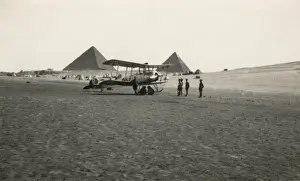 Pyramids Prints: A biplane in the Egyptian desert, with the pyramids