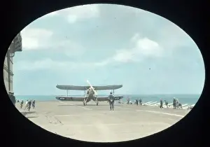 Biplane landing on an aircraft carrier