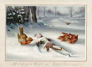 Birds with wooden doll in snow on a Christmas card