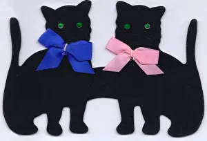 Two black cats made of felt