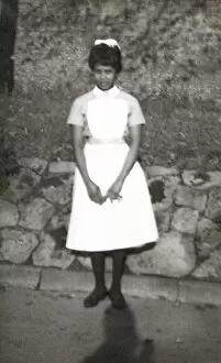 Mixture Gallery: Black nurse standing by a wall in the grounds of Womans Hos