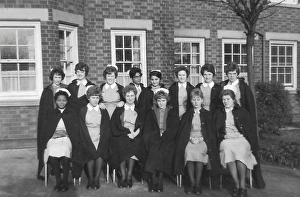 Black nurses amongst white nurses having a group picture